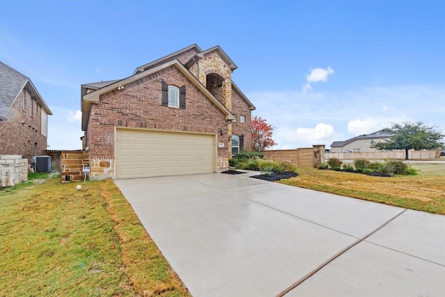 front facade with a front lawn, cooling unit, and a garage