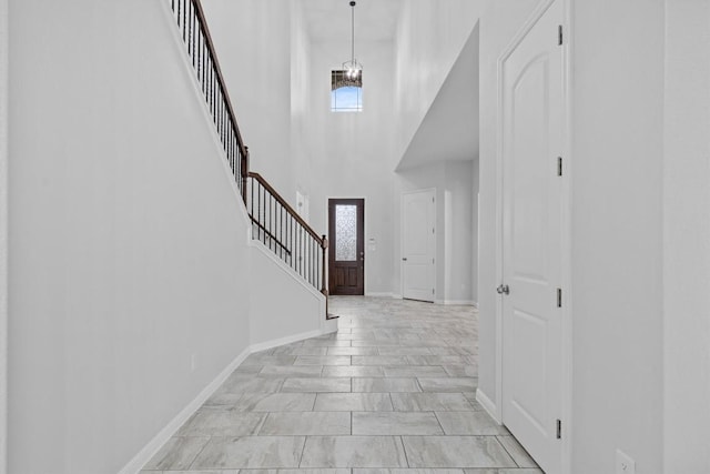 foyer entrance with a high ceiling and a chandelier