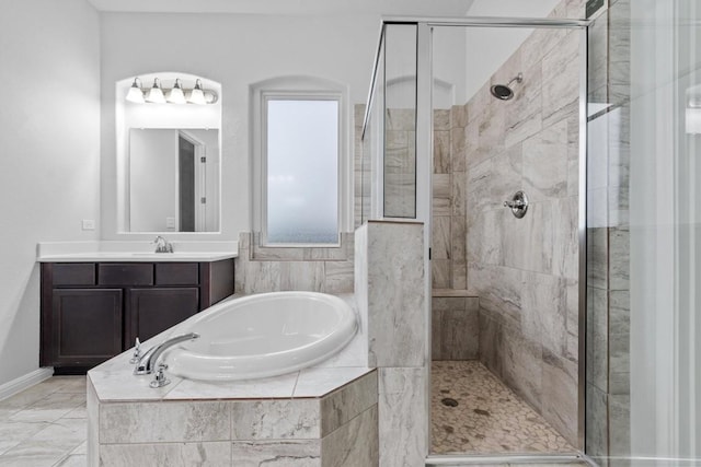 bathroom featuring vanity and shower with separate bathtub