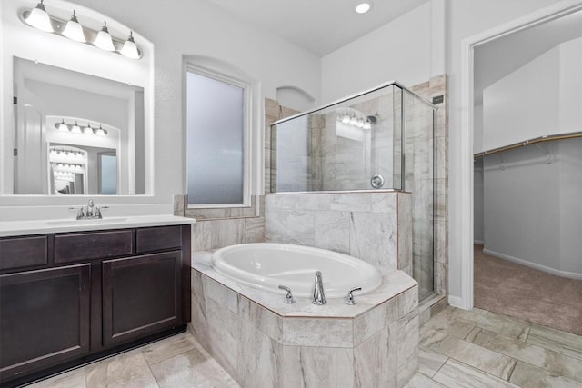 bathroom with vanity and separate shower and tub