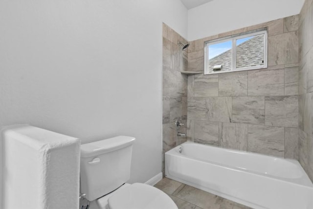 bathroom featuring toilet and tiled shower / bath