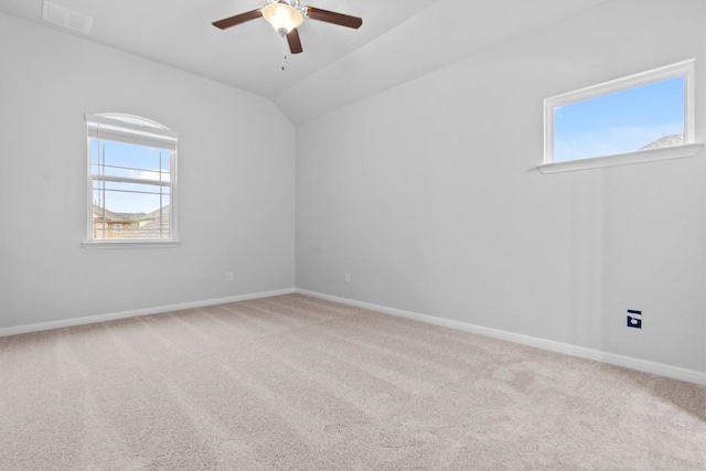 carpeted spare room featuring ceiling fan and lofted ceiling