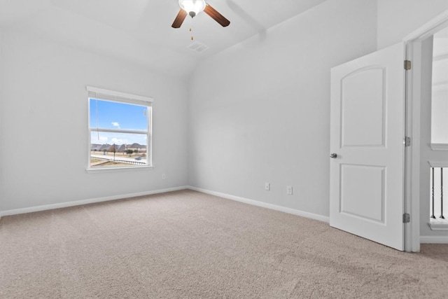 carpeted empty room with ceiling fan and lofted ceiling