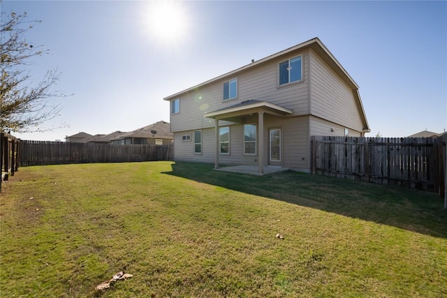 back of property featuring a patio area and a lawn