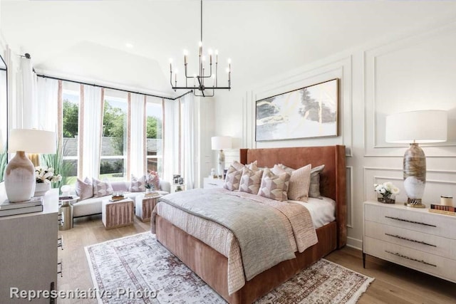 bedroom featuring light hardwood / wood-style floors and a chandelier