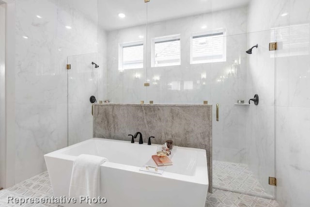 bathroom with independent shower and bath and tile walls