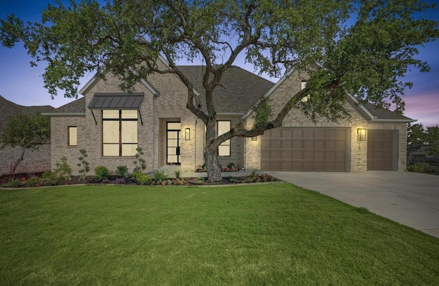 790 Old Stone Rd, Austin, TX 78737 - view of front of property featuring a garage, driveway, a front lawn, and brick siding
