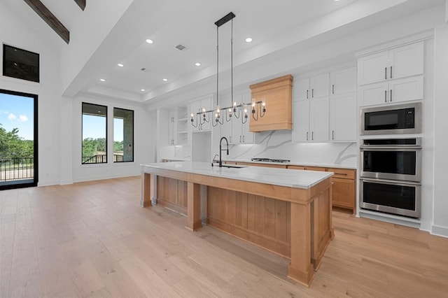790 Old Stone Rd, Austin, TX 78737 - kitchen featuring a sink, built in microwave, stainless steel double oven, light wood-style flooring, and recessed lighting