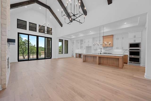 790 Old Stone Rd, Austin, TX 78737 - kitchen with recessed lighting, high vaulted ceiling, open floor plan, light wood-style floors, and beam ceiling