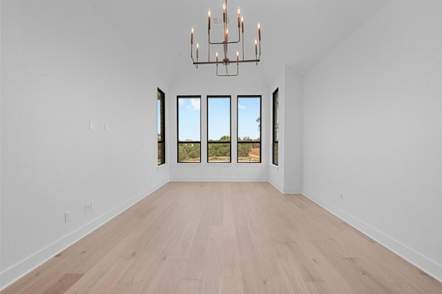 790 Old Stone Rd, Austin, TX 78737 - spare room featuring a chandelier, light wood-type flooring, baseboards, and a towering ceiling