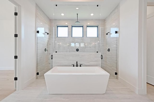 790 Old Stone Rd, Austin, TX 78737 - bathroom with a soaking tub, a stall shower, baseboards, and recessed lighting