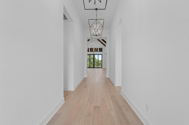 790 Old Stone Rd, Austin, TX 78737 - hall featuring a chandelier, light wood-style flooring, and baseboards