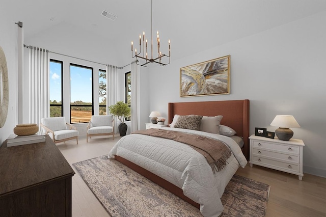 790 Old Stone Rd, Austin, TX 78737 - bedroom featuring a chandelier, wood finished floors, and a high ceiling