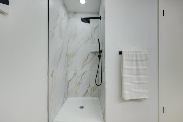 bathroom with tiled shower