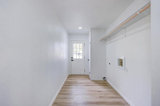 laundry room with hookup for an electric dryer, hookup for a washing machine, and light hardwood / wood-style flooring