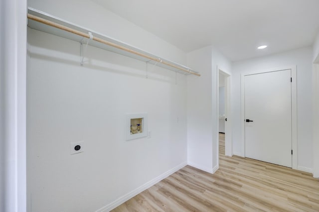 washroom with electric dryer hookup, hookup for a washing machine, and light hardwood / wood-style flooring