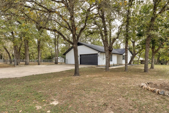 view of front of home featuring a garage and a front lawn