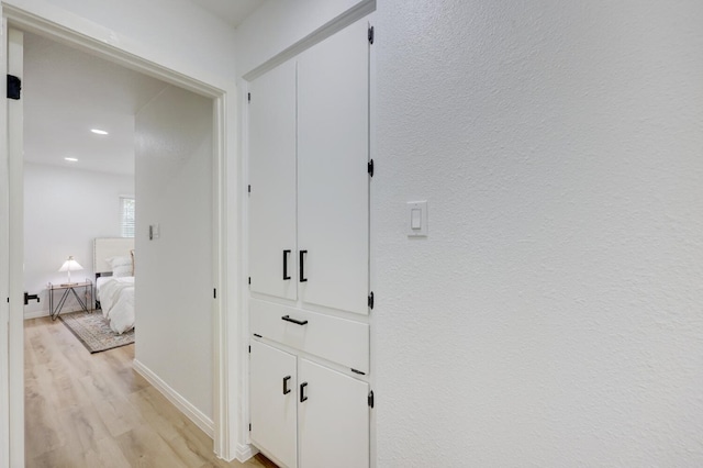 hall with light hardwood / wood-style flooring