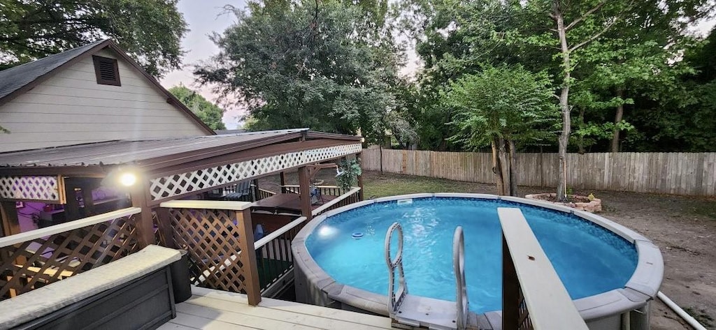 view of swimming pool with a wooden deck