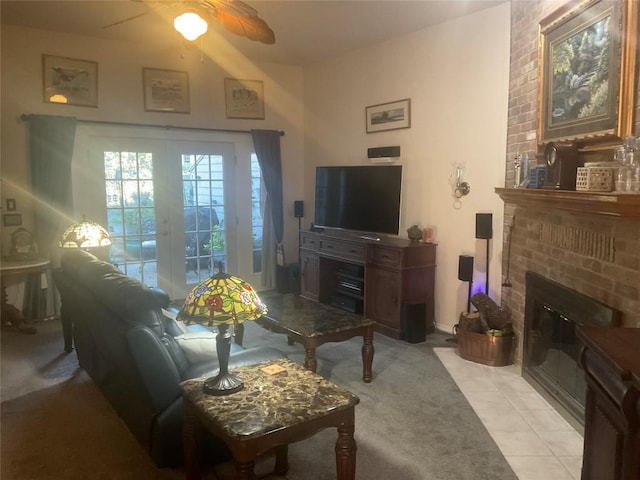 tiled living room featuring ceiling fan and a brick fireplace