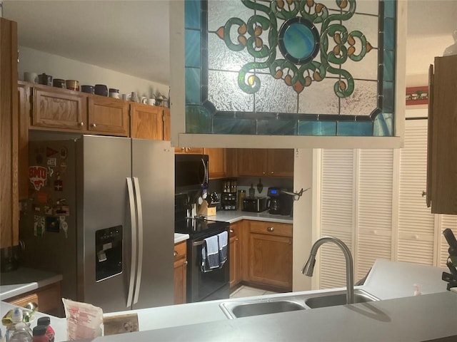 kitchen with sink and black appliances