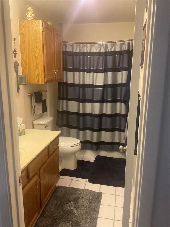 bathroom with tile patterned floors, vanity, and toilet