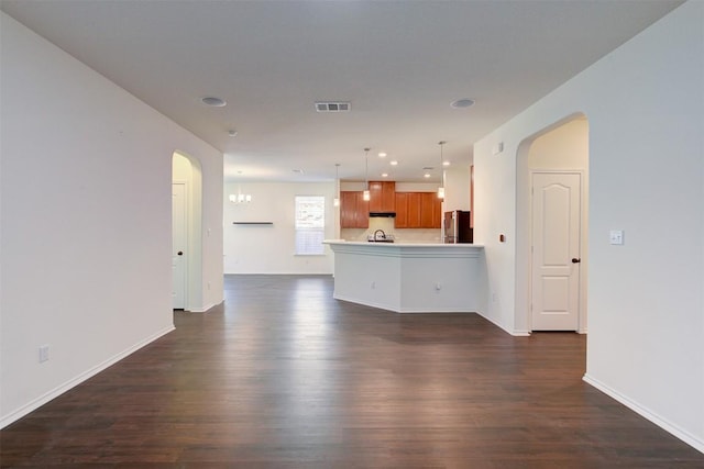 unfurnished living room featuring dark hardwood / wood-style flooring