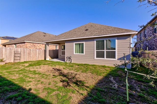 back of property featuring a yard and a patio area