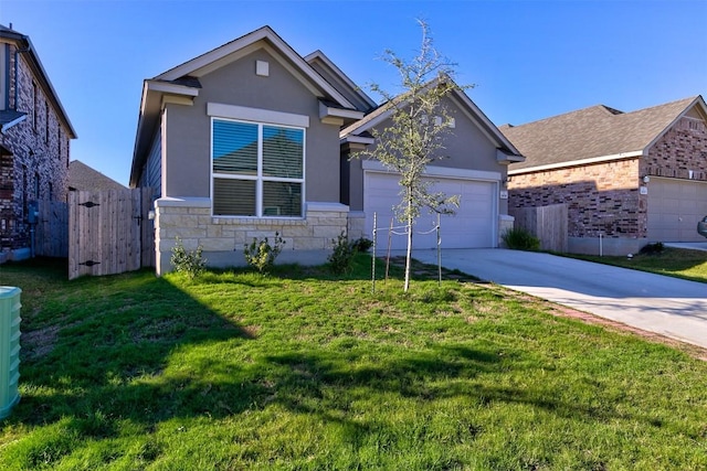 view of front of house featuring a garage and a front lawn