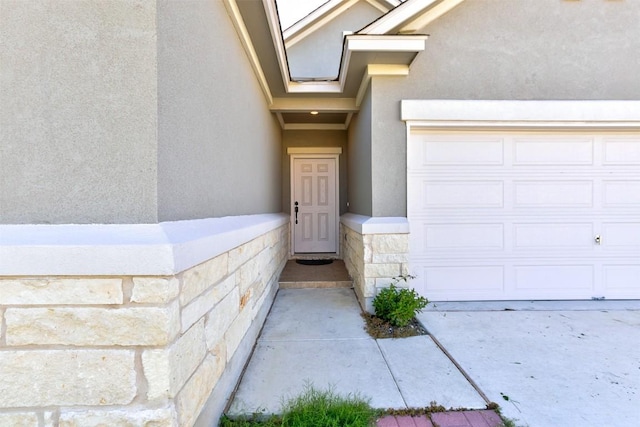 view of exterior entry with a garage