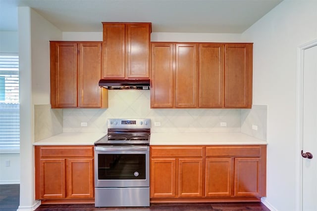 kitchen with decorative backsplash, electric range, and dark wood-type flooring