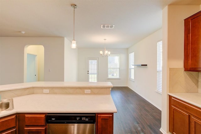 kitchen featuring tasteful backsplash, stainless steel dishwasher, pendant lighting, a chandelier, and dark hardwood / wood-style floors