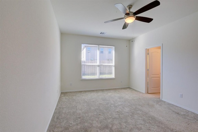 carpeted spare room with ceiling fan