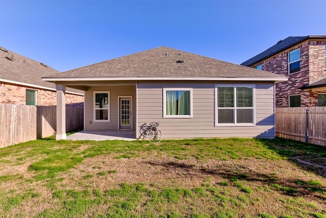 rear view of property featuring a patio area and a yard