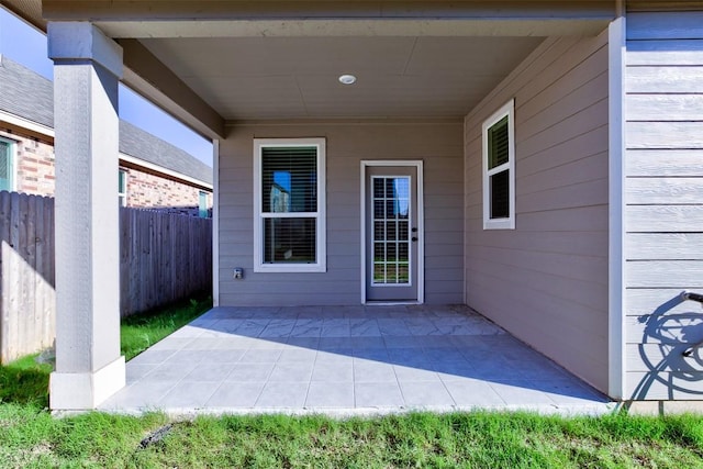 view of exterior entry featuring a patio area