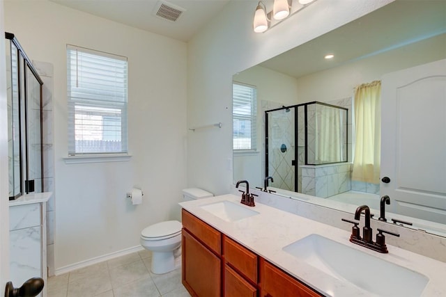 bathroom with tile patterned flooring, vanity, toilet, and an enclosed shower