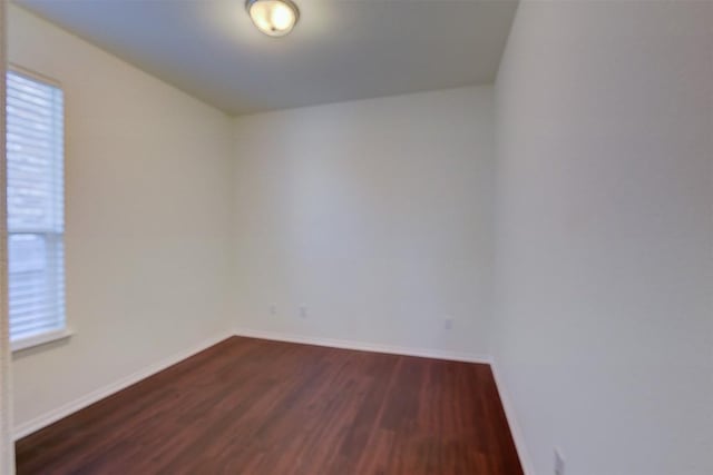 spare room featuring dark hardwood / wood-style floors