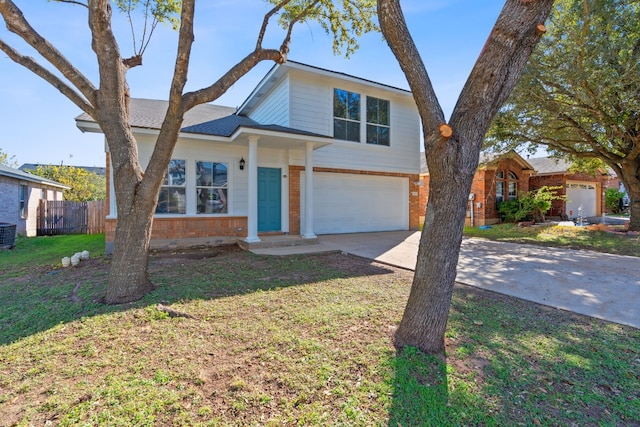 view of front of house featuring cooling unit, a front yard, and a garage