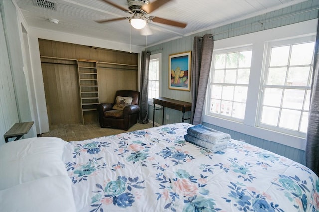 bedroom featuring a closet, crown molding, ceiling fan, and hardwood / wood-style flooring