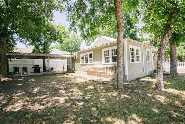 back of house with a patio and fence