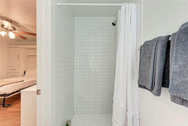 bathroom with a shower with curtain, ceiling fan, and hardwood / wood-style flooring