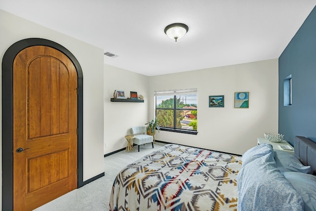 bedroom featuring light carpet