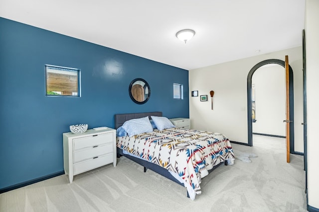 bedroom featuring light colored carpet