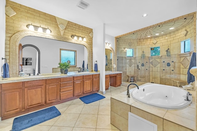 bathroom featuring tile patterned flooring, vanity, separate shower and tub, and tile walls