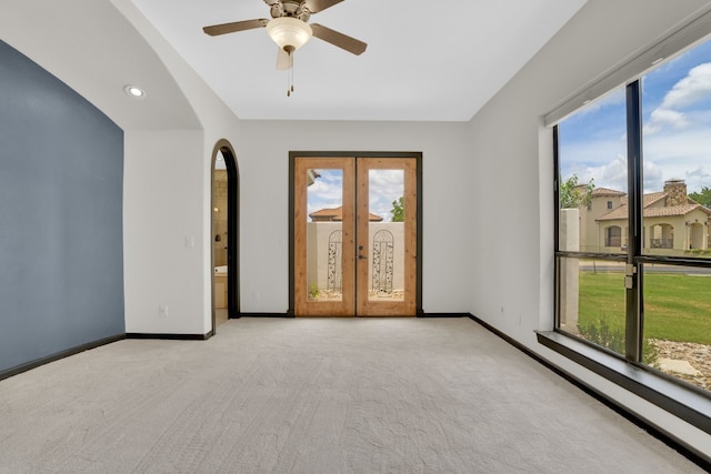 spare room featuring light carpet and ceiling fan