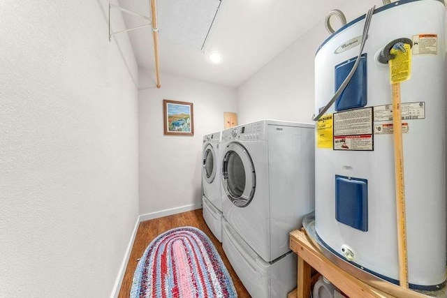 clothes washing area featuring hardwood / wood-style flooring, independent washer and dryer, and electric water heater