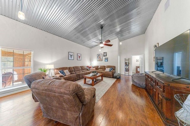 living room featuring ceiling fan, high vaulted ceiling, and hardwood / wood-style flooring