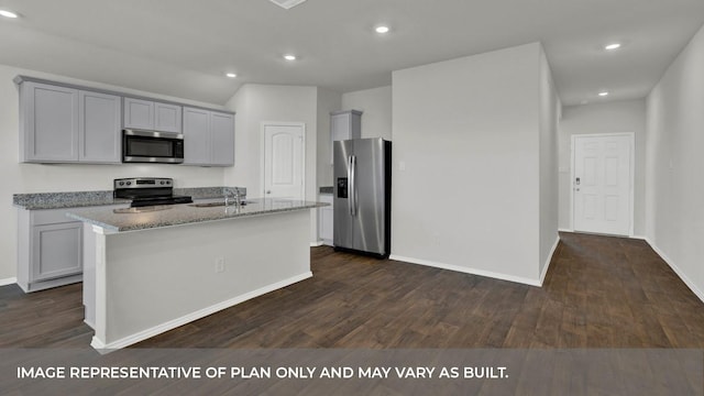 kitchen featuring an island with sink, appliances with stainless steel finishes, light stone countertops, and dark hardwood / wood-style flooring