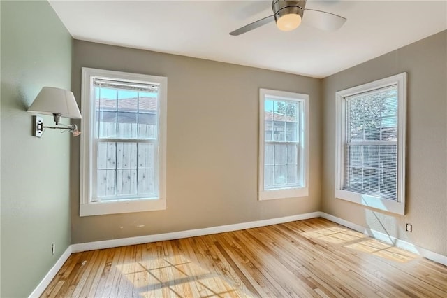 unfurnished room with light wood-type flooring, plenty of natural light, and ceiling fan