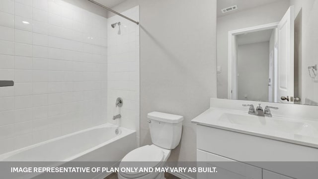 full bathroom featuring tiled shower / bath combo, toilet, and vanity